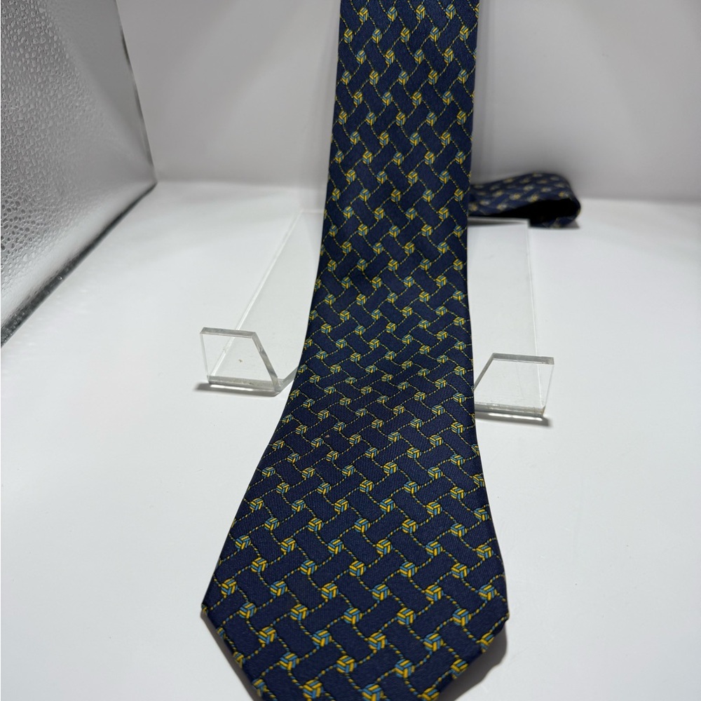 Hermes Vintage tie. This blue and gold piece in a knot cufflink pattern.